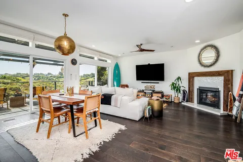 a view of a livingroom with furniture window and wooden floor