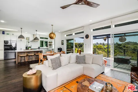 a living room with furniture fireplace and window