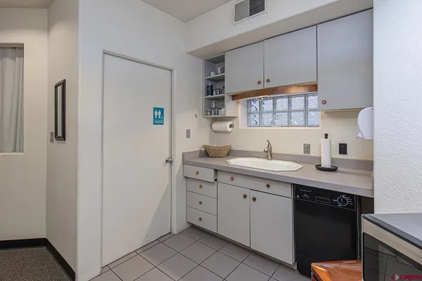 a kitchen with a sink and cabinets