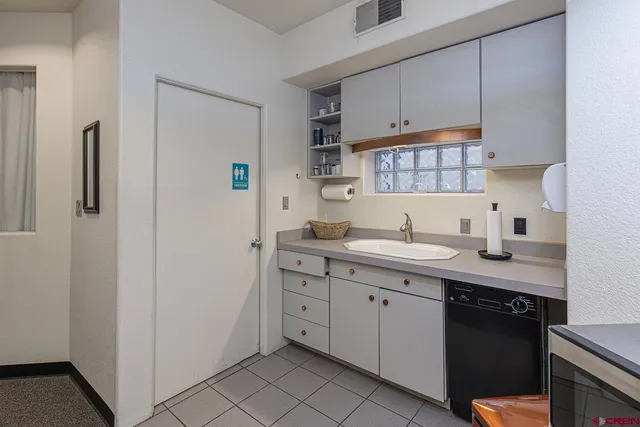 a kitchen with a sink and cabinets