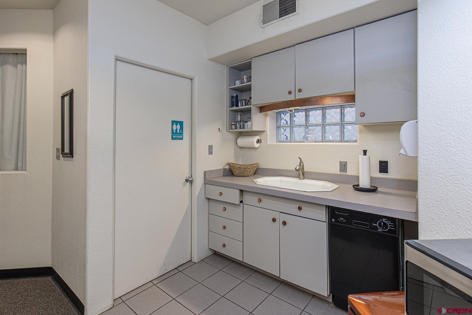 1221 Main Avenue Durango, CO 81301 - Photo 13 of 31 a kitchen with a sink and cabinets