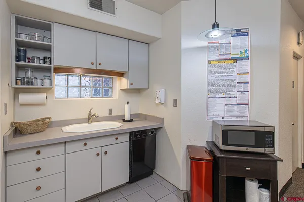 a kitchen with a sink and cabinets