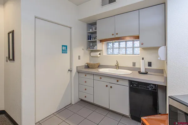 a kitchen with a sink cabinets and appliances