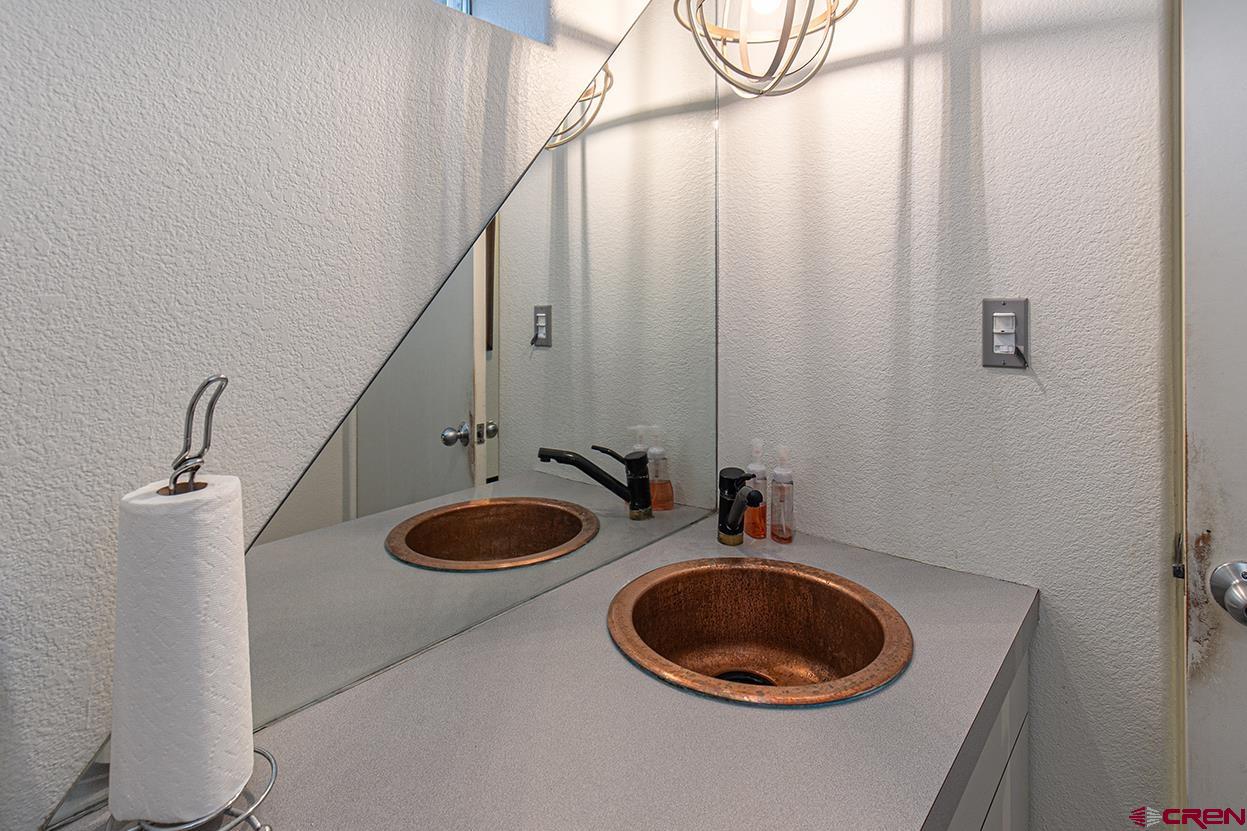 1221 Main Avenue Durango, CO 81301 - Photo 17 of 31 a bathroom with a sink and a mirror