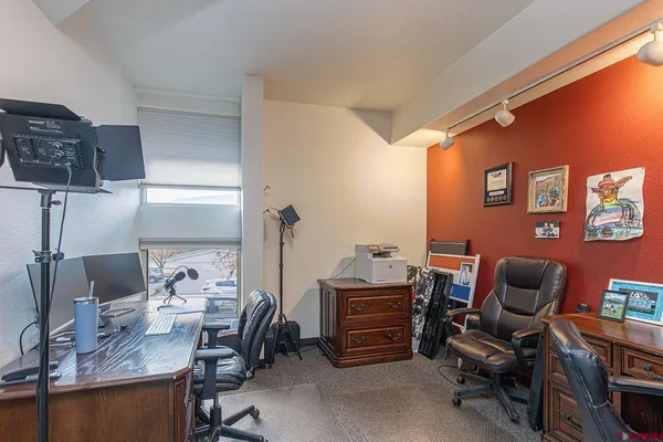 a work room with furniture and a wooden floor