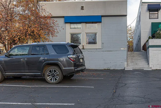 a front view of a house with parking space