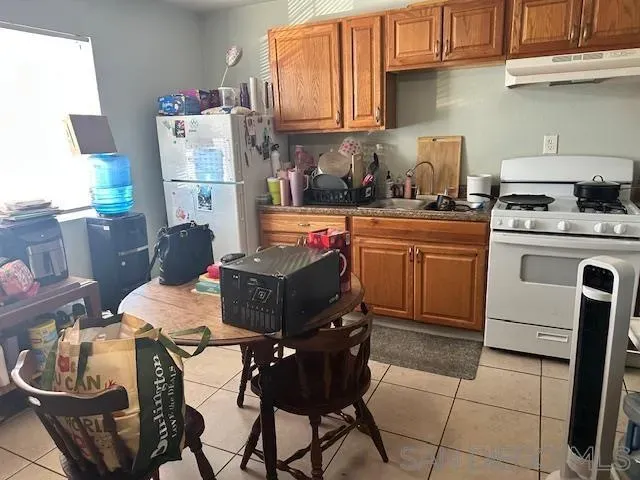 a kitchen with a sink refrigerator and cabinets