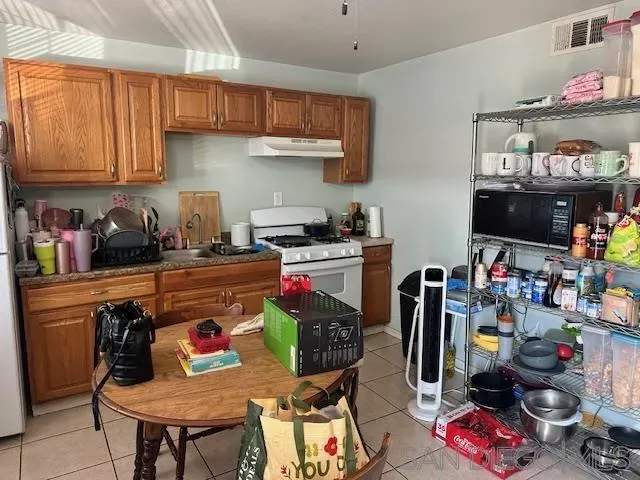 a kitchen with stainless steel appliances granite countertop a sink dishwasher and cabinets with wooden floor