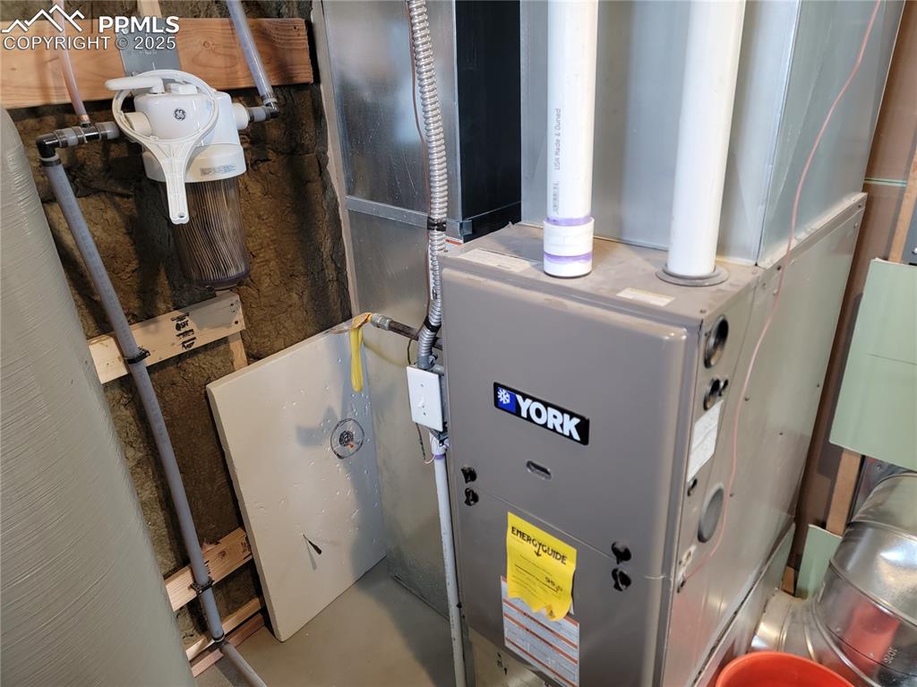 32174 Torrence Road Yoder, CO 80864 - Photo 21 of 27 a bathroom with a toilet and a mirror