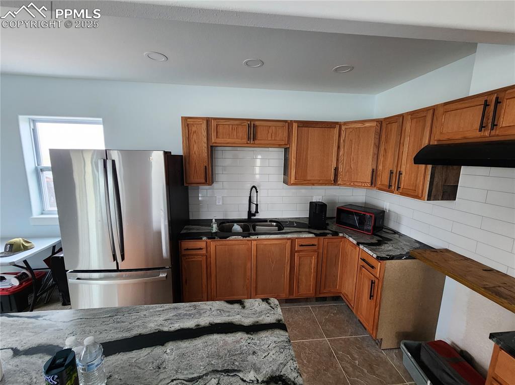 32174 Torrence Road Yoder, CO 80864 - Photo 27 of 27 a kitchen with granite countertop a refrigerator stove and sink