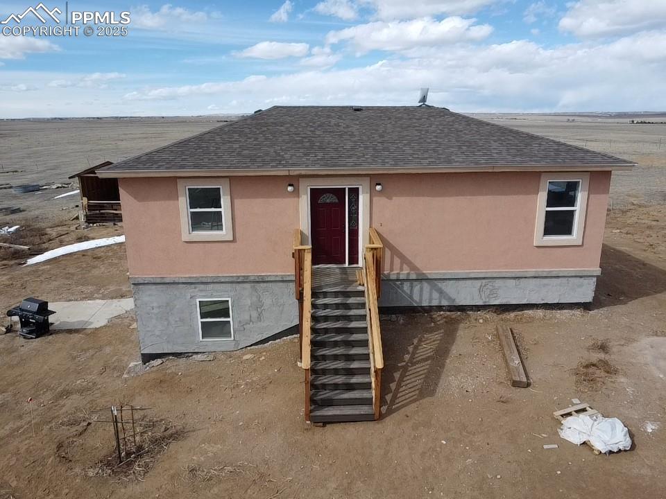 32174 Torrence Road Yoder, CO 80864 - Photo 5 of 27 a front view of a house with a yard