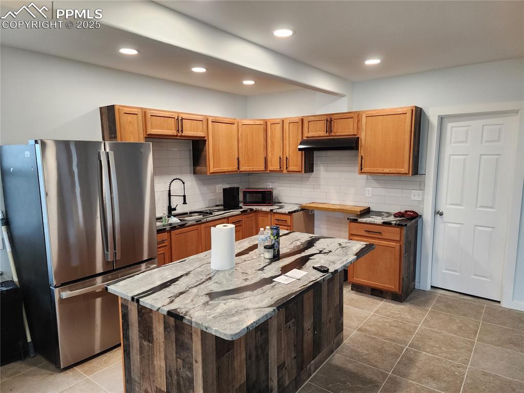 32174 Torrence Road Yoder, CO 80864 - Photo 6 of 27 a kitchen with stainless steel appliances granite countertop a stove a refrigerator a sink a oven and a refrigerator