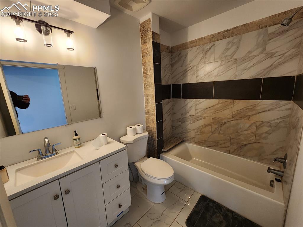 32174 Torrence Road Yoder, CO 80864 - Photo 9 of 27 a bathroom with a double vanity sink toilet and shower