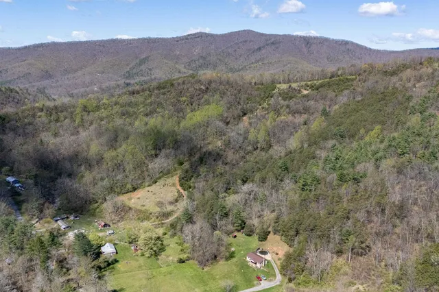a view of a mountain range with trees in the background