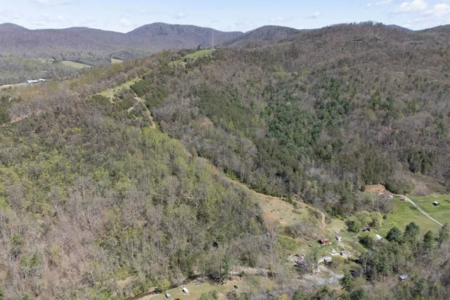 a view of a mountain range with trees in the background