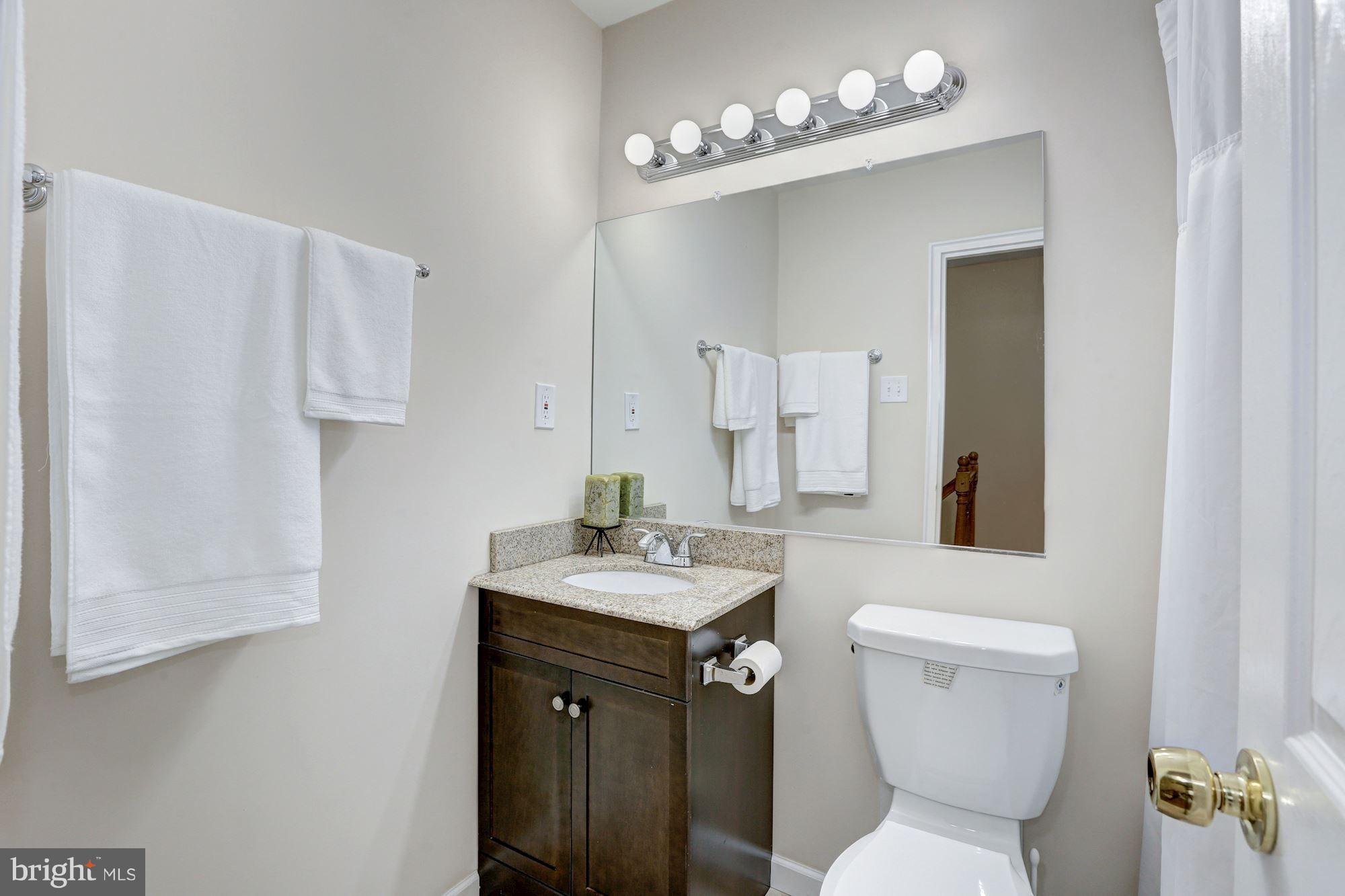 13108 Holdridge Road Silver Spring, MD 20906 - Photo 16 of 30 a bathroom with a toilet a sink and a mirror