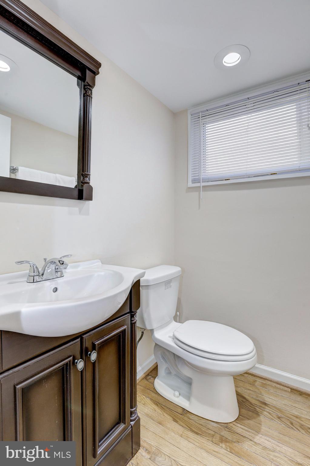 13108 Holdridge Road Silver Spring, MD 20906 - Photo 21 of 30 a bathroom with a sink a toilet a mirror and vanity