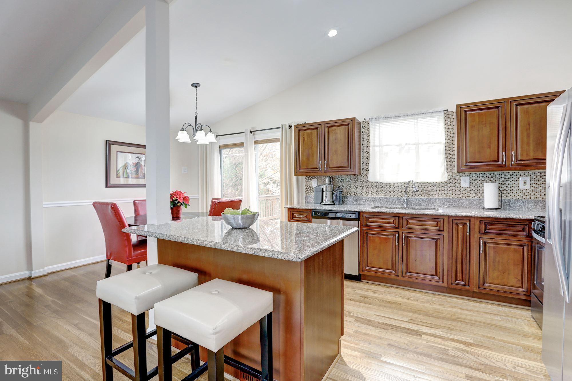 13108 Holdridge Road Silver Spring, MD 20906 - Photo 8 of 30 a kitchen with a dining table chairs and wooden floor