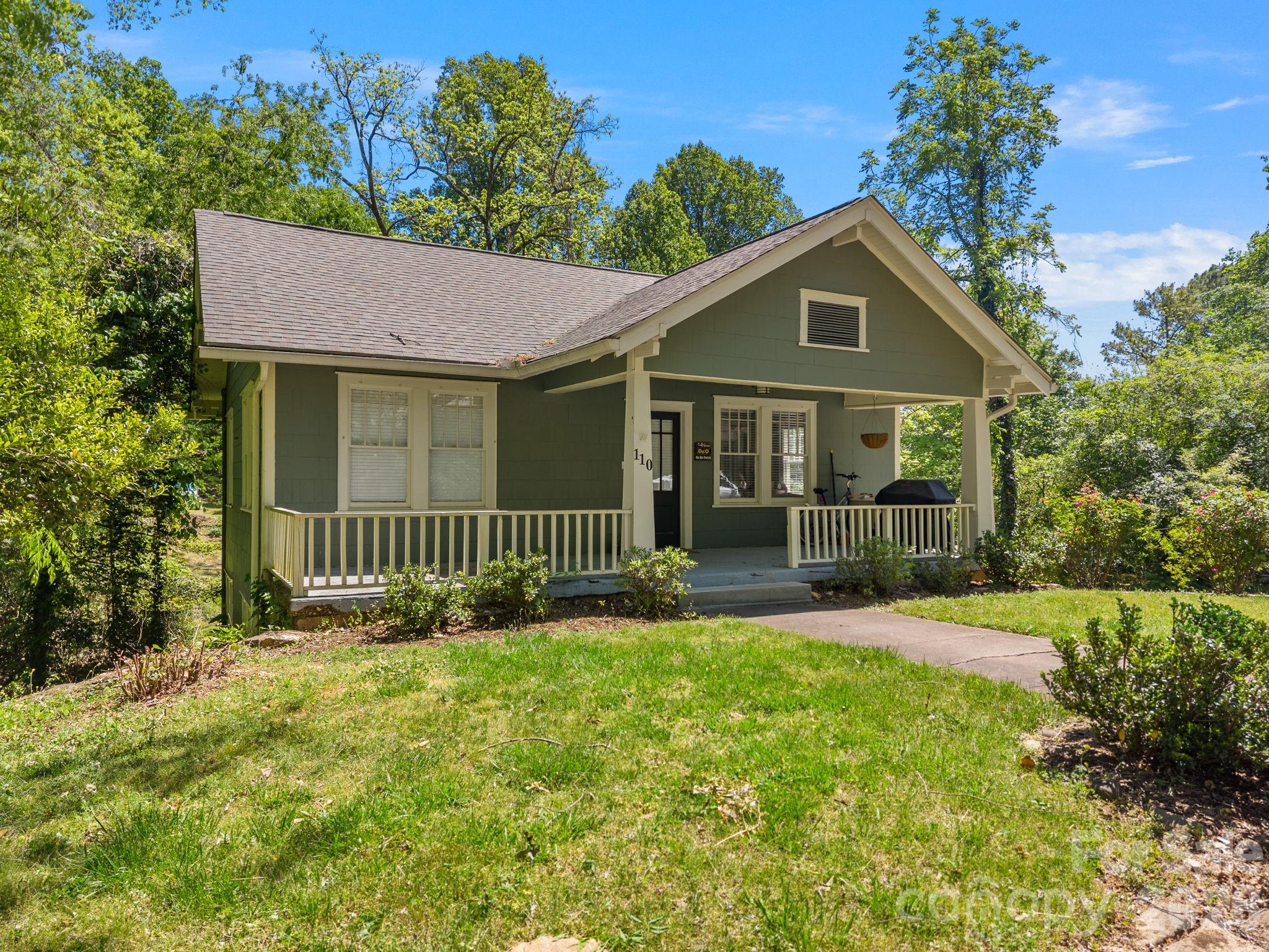 110 Grady Avenue Tryon, NC 28782 - Photo 1 of 41 a front view of a house with a yard