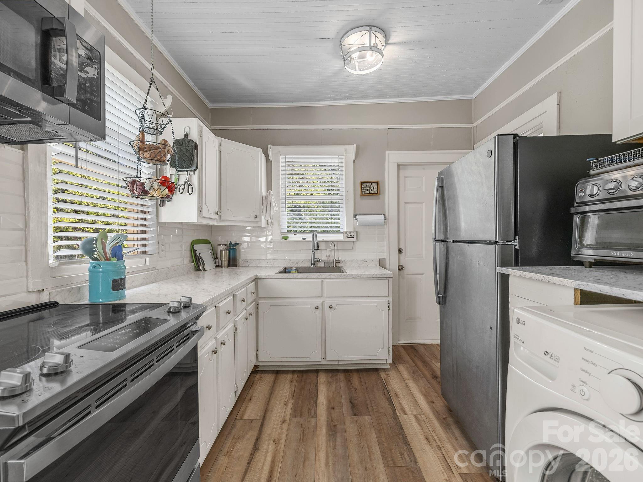 110 Grady Avenue Tryon, NC 28782 - Photo 15 of 41 a kitchen with a sink stove and refrigerator