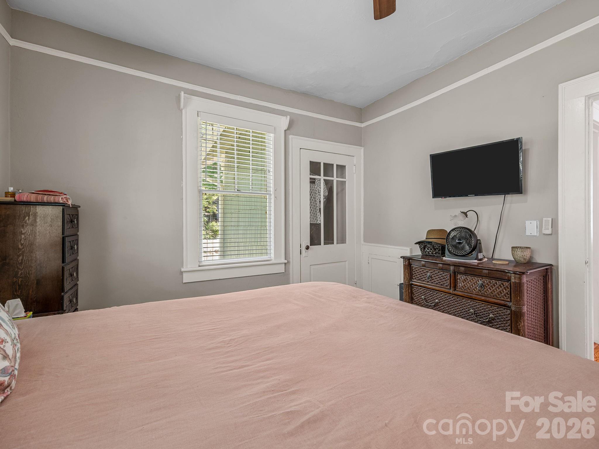 110 Grady Avenue Tryon, NC 28782 - Photo 21 of 41 a bedroom with a bed and a flat screen tv