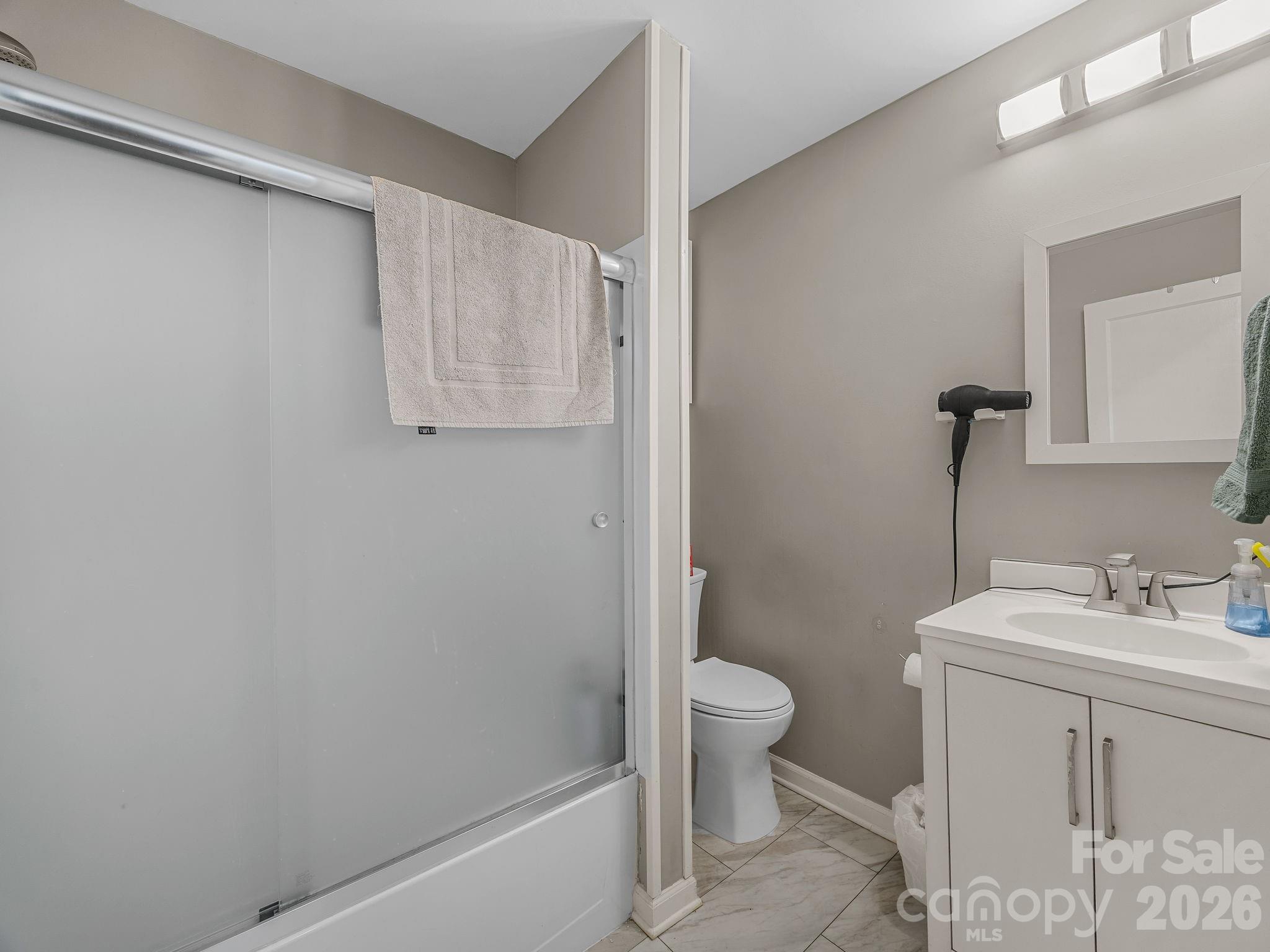 110 Grady Avenue Tryon, NC 28782 - Photo 22 of 41 a bathroom with a sink toilet and vanity