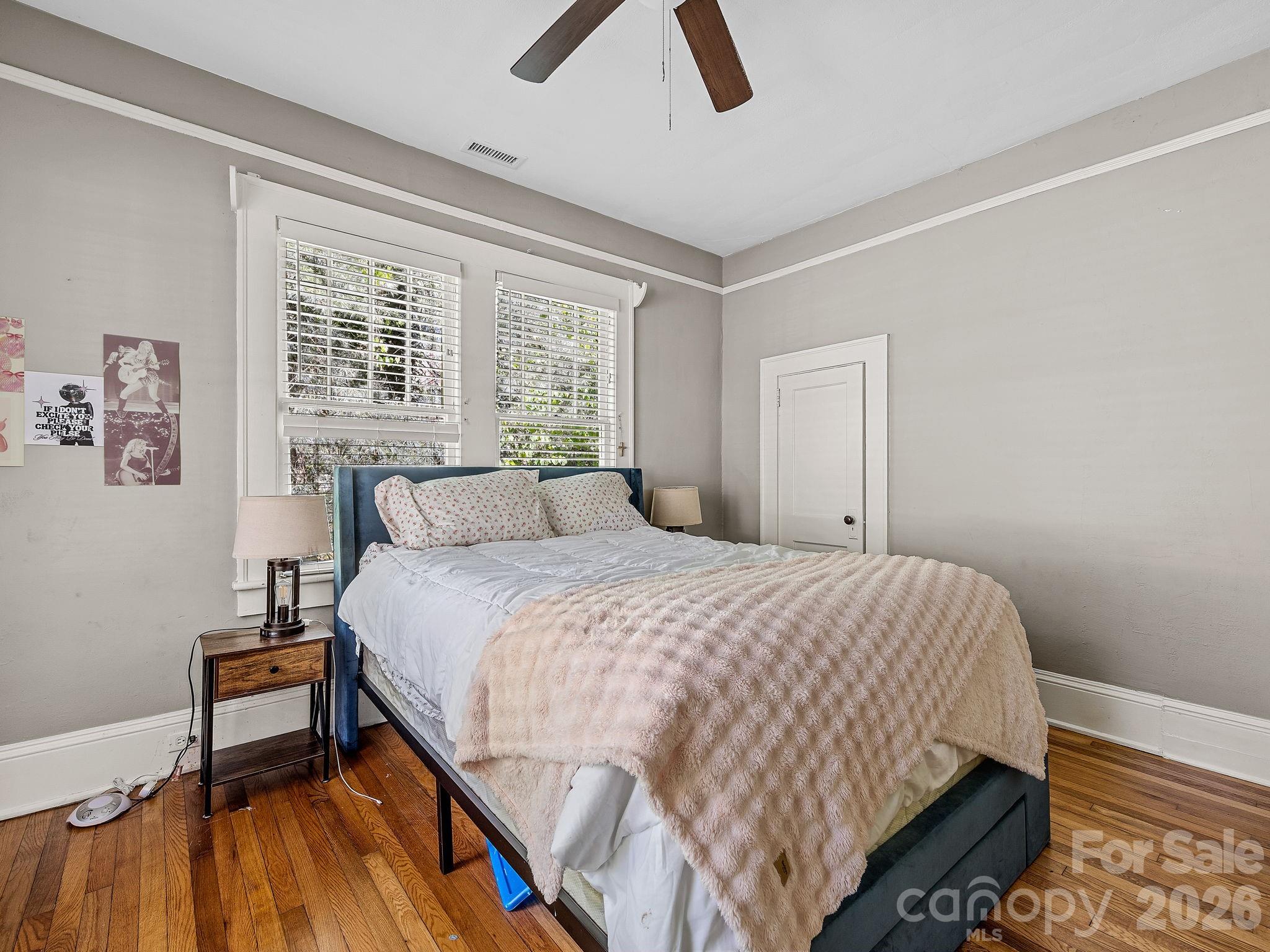 110 Grady Avenue Tryon, NC 28782 - Photo 24 of 41 a bedroom with a bed and painting on the wall