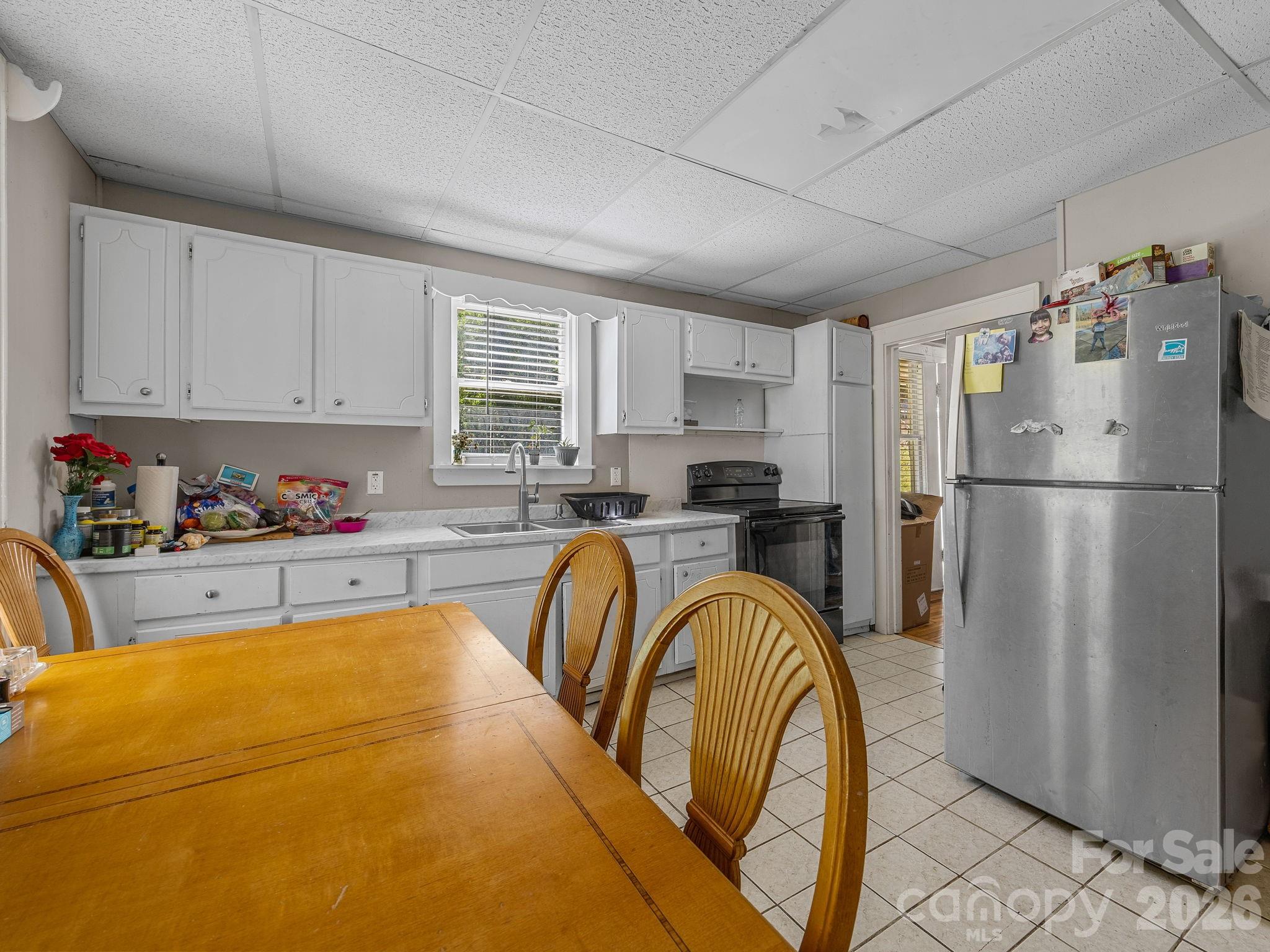 110 Grady Avenue Tryon, NC 28782 - Photo 32 of 41 a kitchen with stainless steel appliances granite countertop a refrigerator sink and cabinets