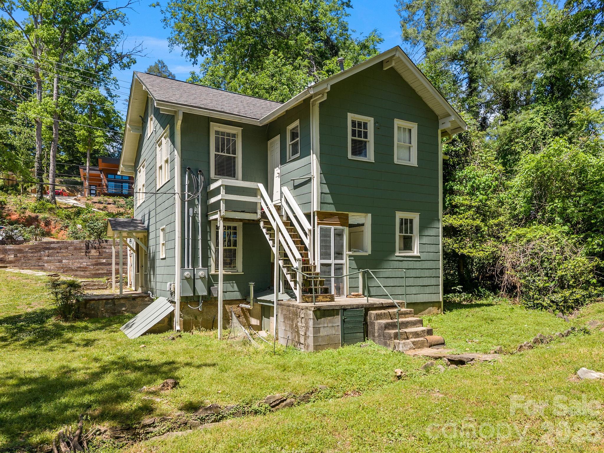 110 Grady Avenue Tryon, NC 28782 - Photo 39 of 41 a view of a house with wooden fence next to a yard