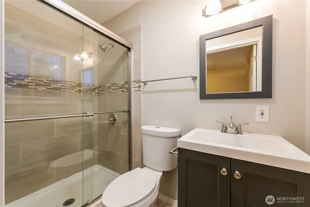 a bathroom with a sink mirror toilet and shower