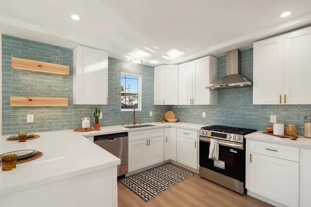 a kitchen with a sink a stove and cabinets