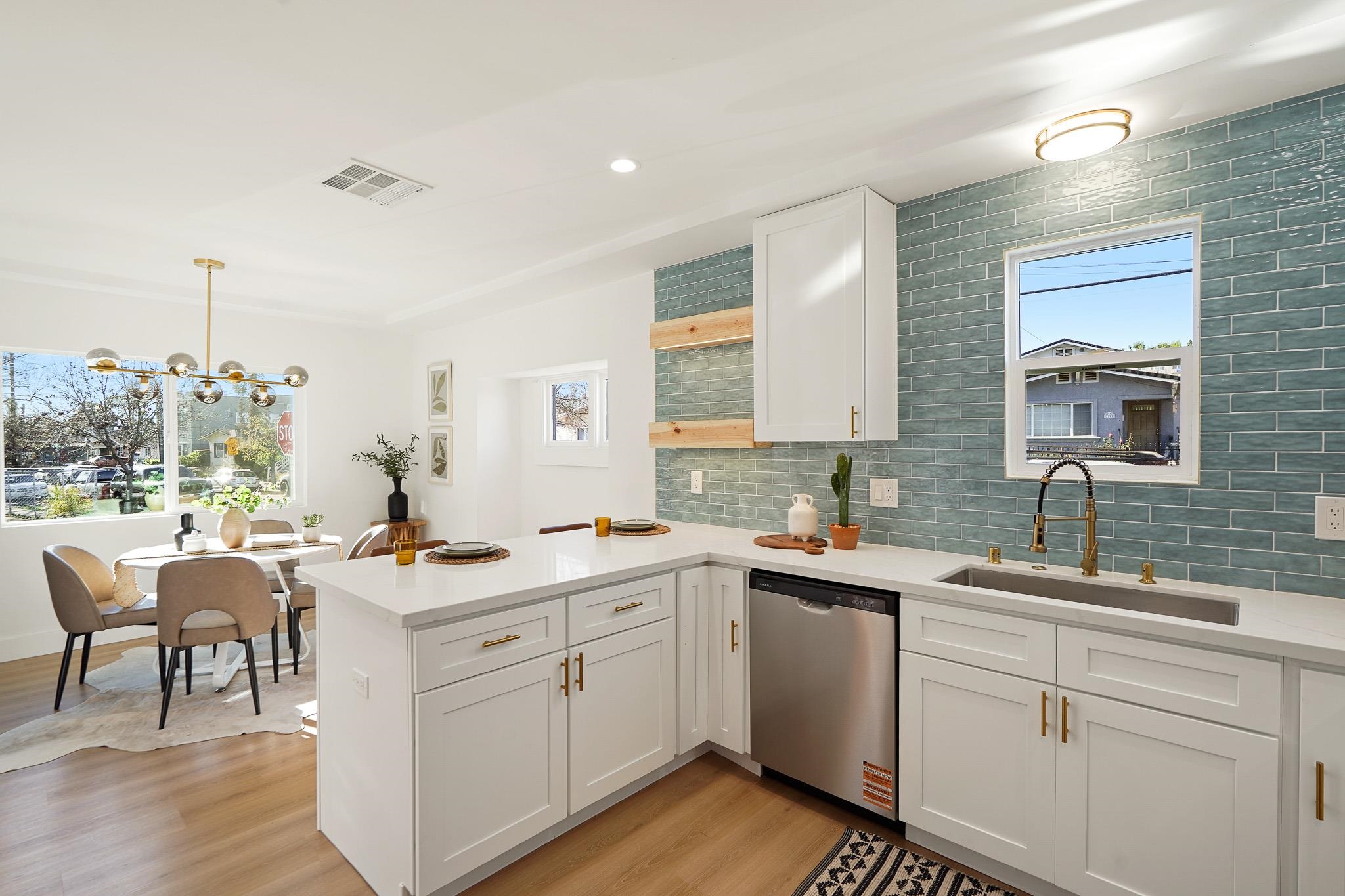 2151 Santa Rita Street Oakland, CA 94601 - Photo 13 of 46 Kitchen with a peninsula, decorative backsplash, stainless steel dishwasher, white cabinetry, and light wood-style floors