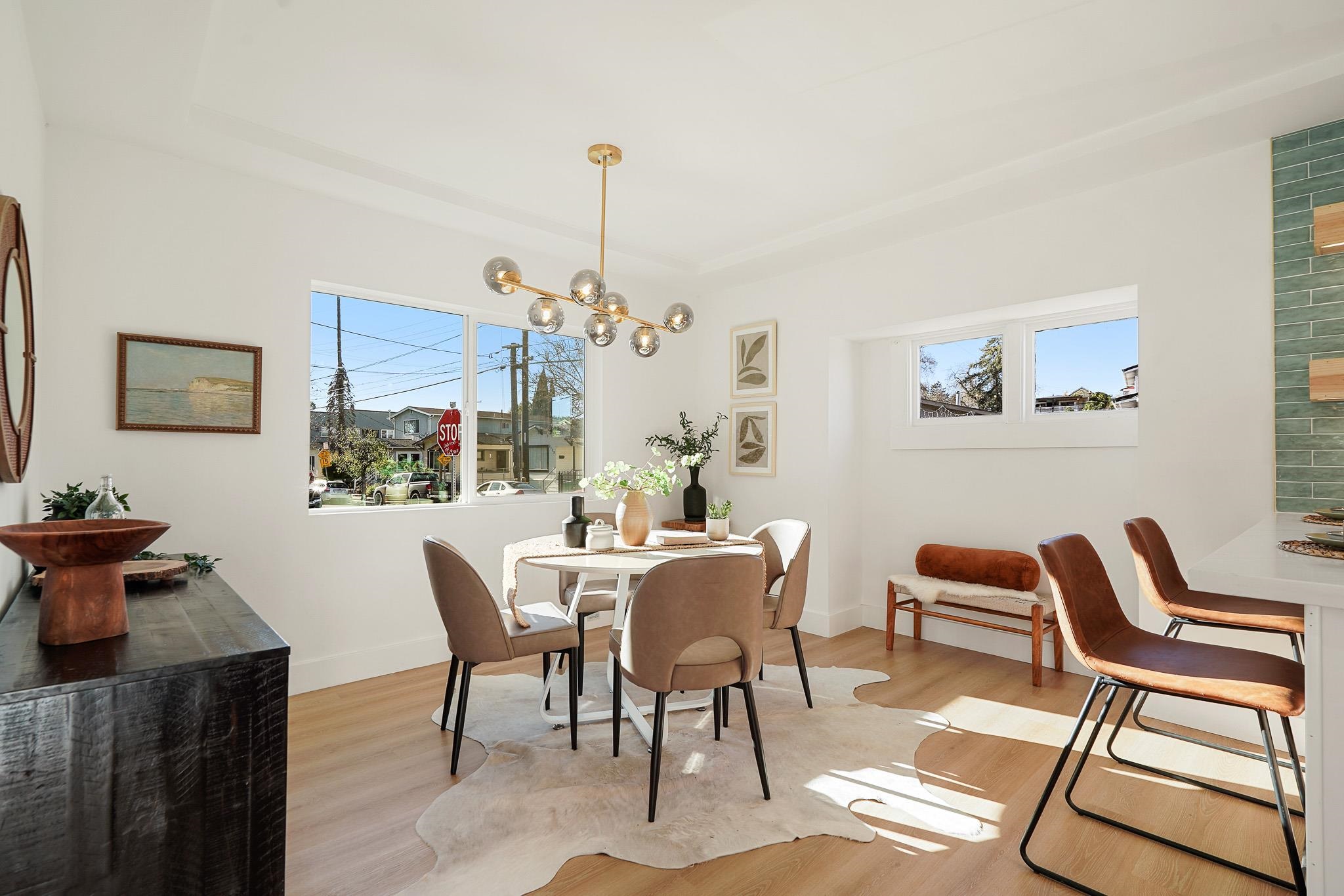 2151 Santa Rita Street Oakland, CA 94601 - Photo 14 of 46 Dining area with plenty of natural light, light wood finished floors, a chandelier, and a raised ceiling