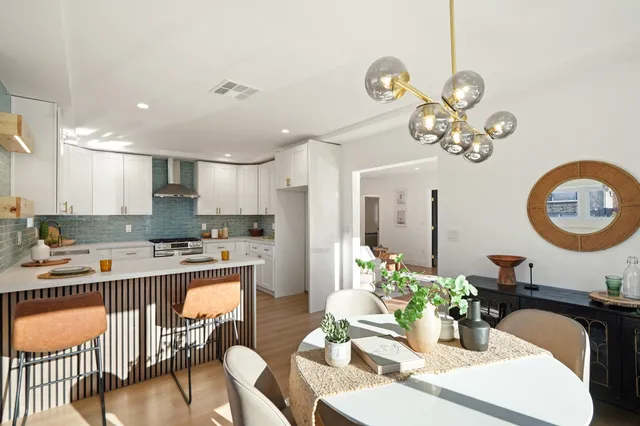 a large kitchen with a table and chairs