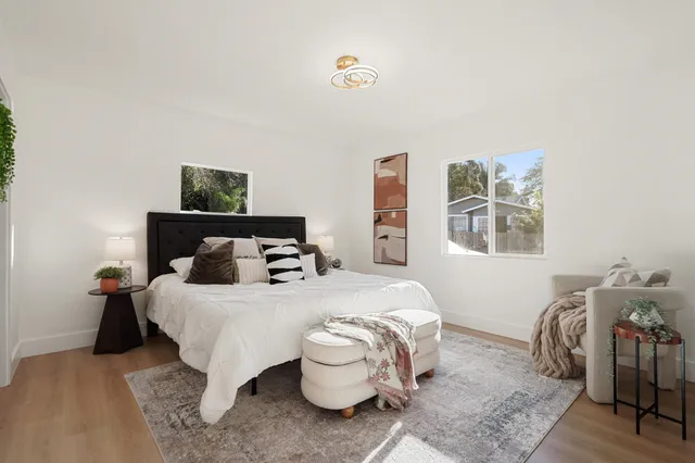 a bedroom with a bed and wooden floor