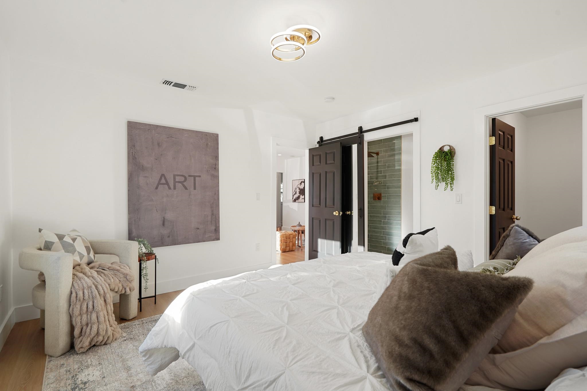 2151 Santa Rita Street Oakland, CA 94601 - Photo 17 of 46 Bedroom with a barn door and wood finished floors