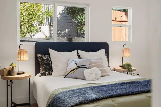 a bedroom with a large bed and a window