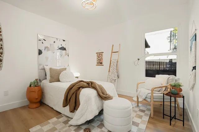 a bedroom with a bed and chair