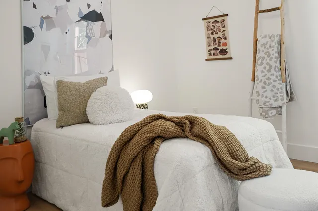 a bedroom with a bed and a couch