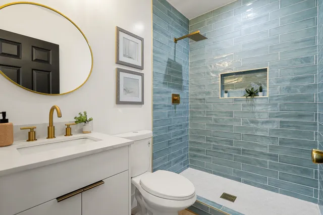 a bathroom with a toilet a sink a mirror and bathtub