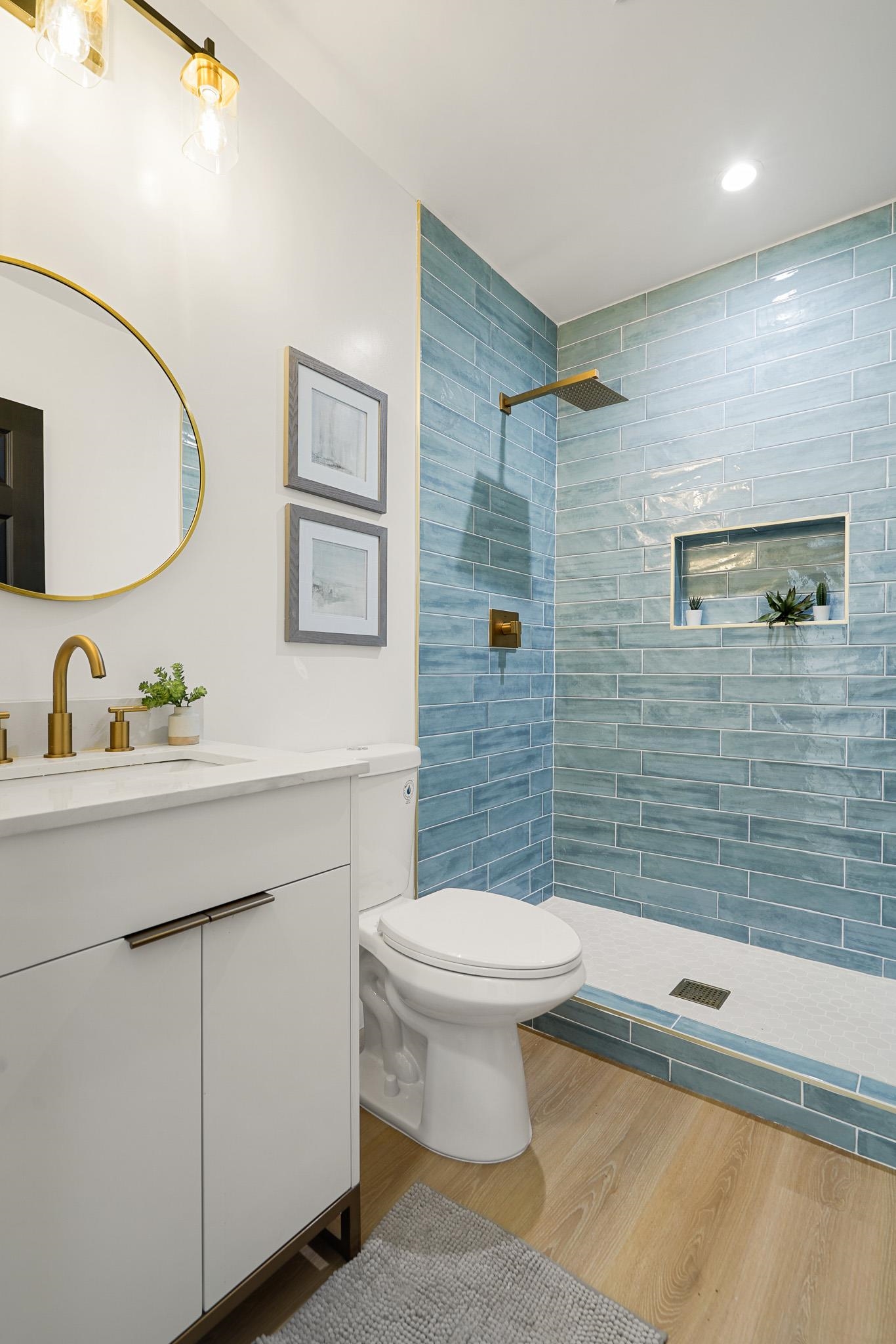 2151 Santa Rita Street Oakland, CA 94601 - Photo 30 of 46 Full bathroom with vanity, a tile shower, and wood finished floors