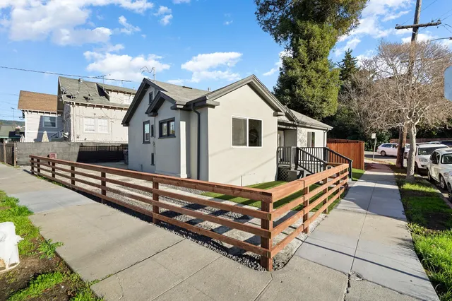 a front view of a house with wooden fence