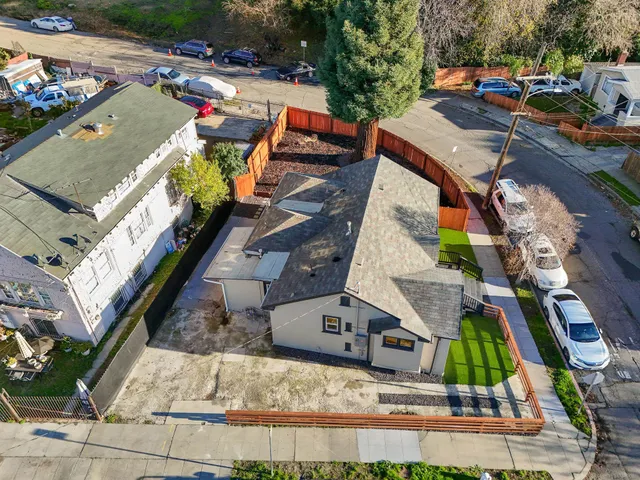 an aerial view of a house with garden space and street view