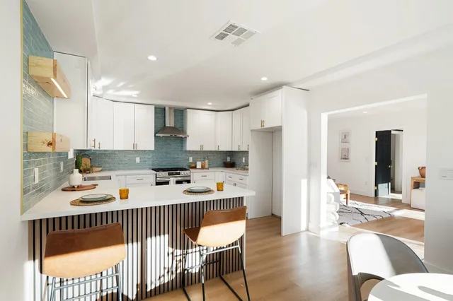 a kitchen with a refrigerator and a stove top oven
