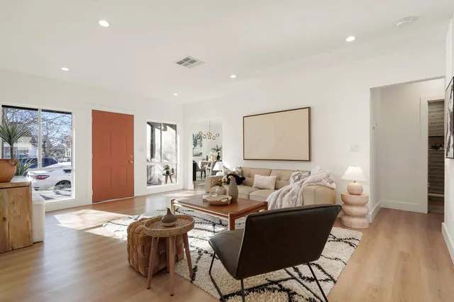 a living room with furniture and wooden floor