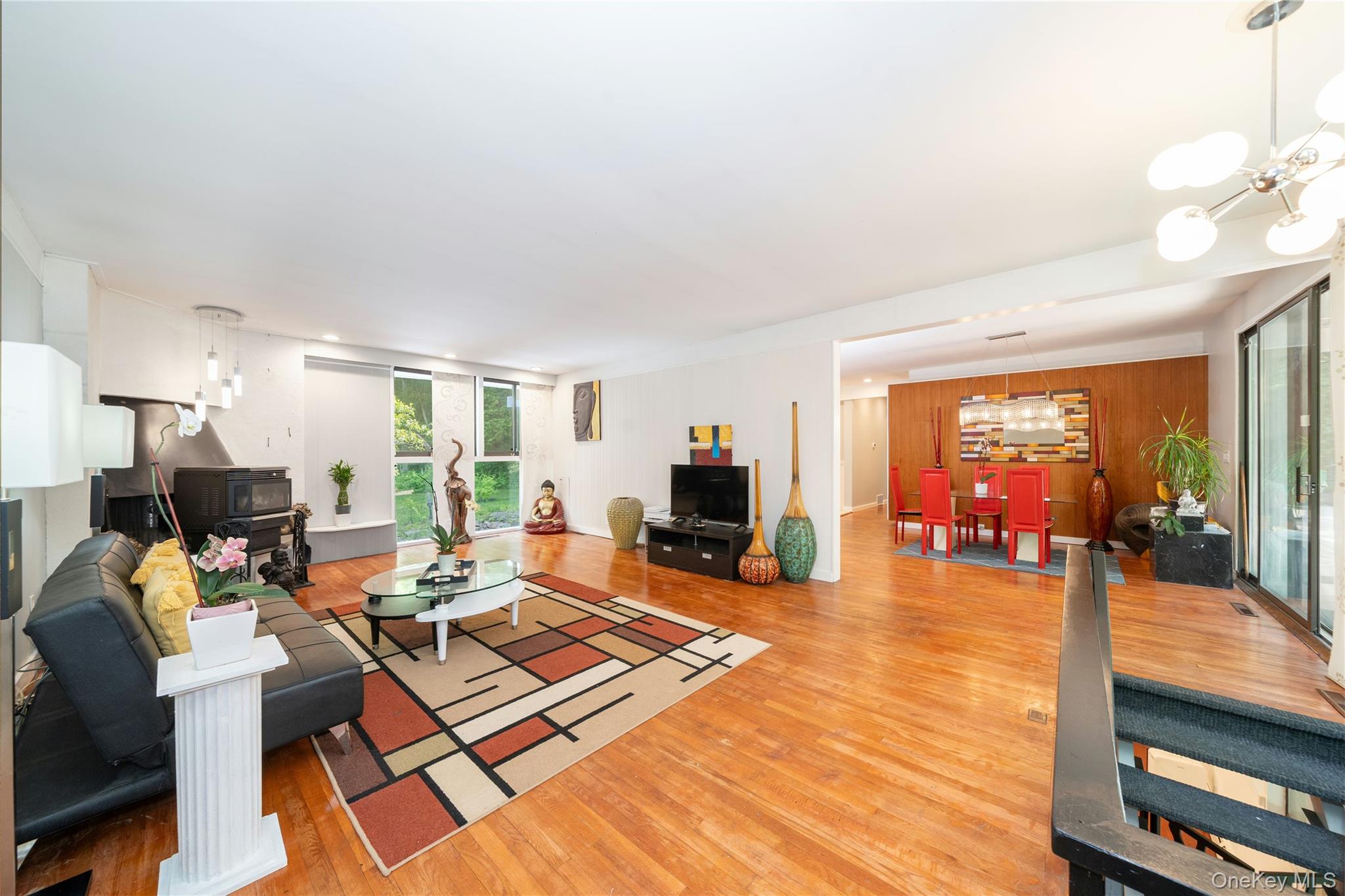 4 Half Mile Road Armonk, NY 10504 - Photo 3 of 28 Open and light-filled mid century modern living area with high ceilings throughout, oversized windows, and a beautiful fireplace.