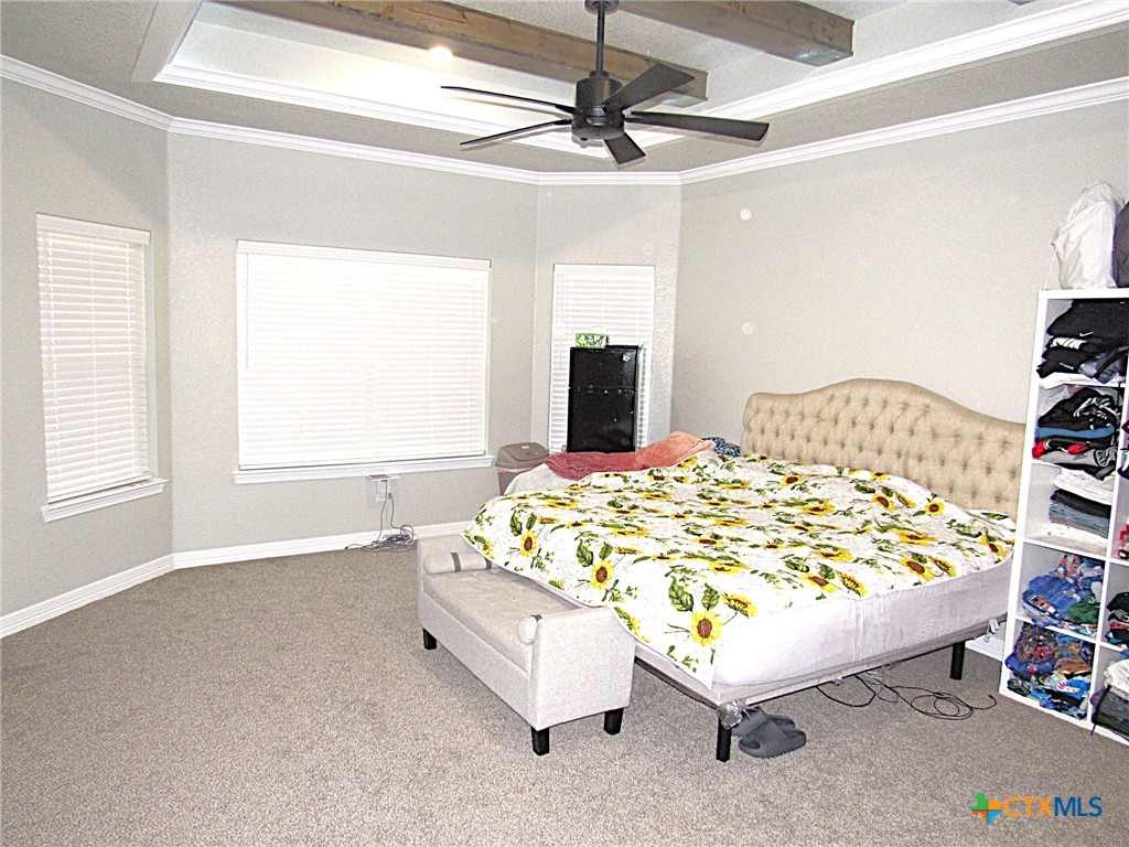 7606 Palladium Loop Killeen, TX 76542 - Photo 25 of 28 a bed sitting in a bedroom next to a window and a chandelier