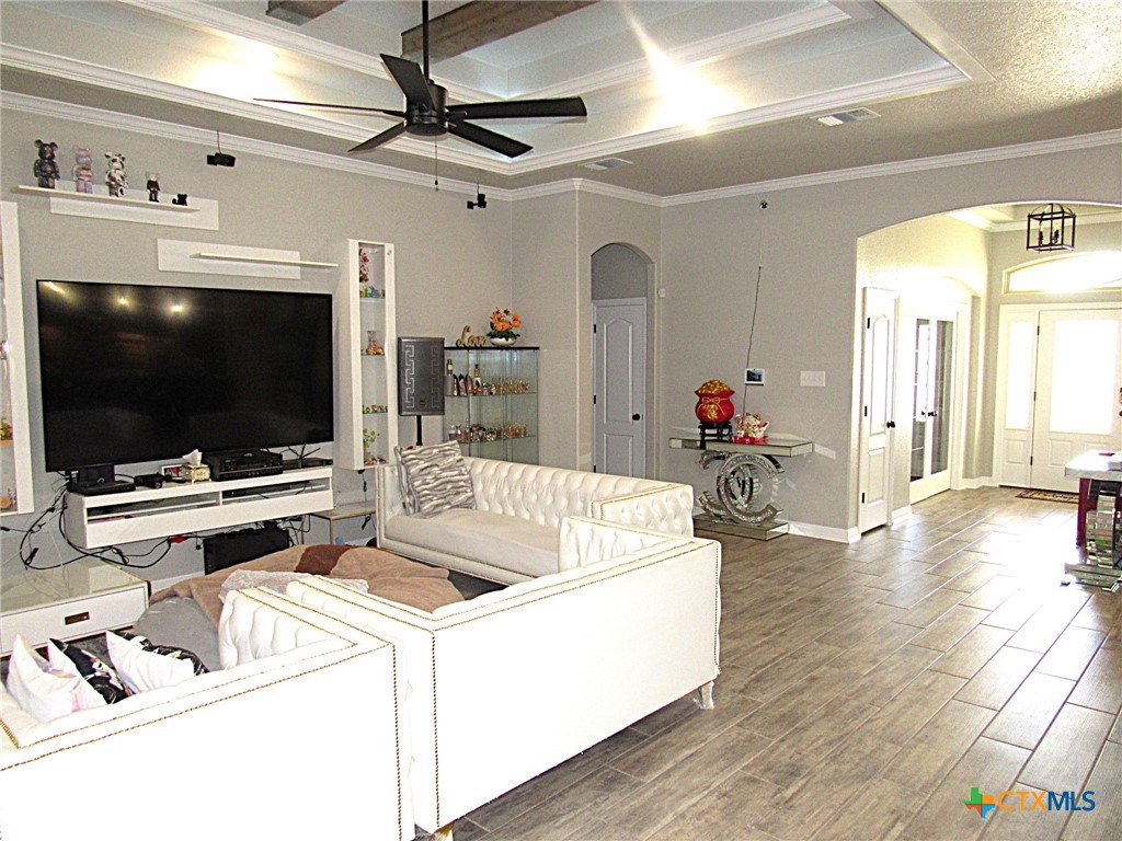 7606 Palladium Loop Killeen, TX 76542 - Photo 4 of 28 a living room with a flat screen tv and a dining table with wooden floor