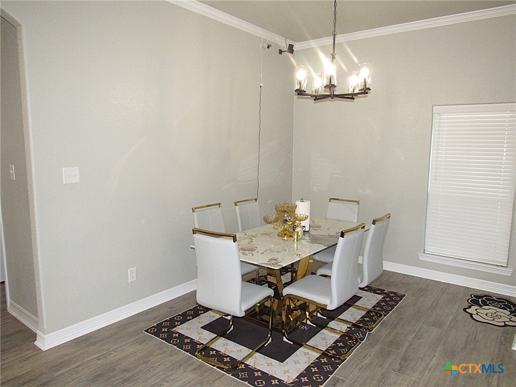 7606 Palladium Loop Killeen, TX 76542 - Photo 7 of 28 a view of a dining room with furniture and wooden floor