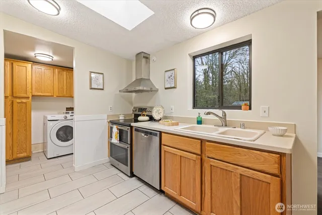 a kitchen with stainless steel appliances granite countertop a sink and cabinets